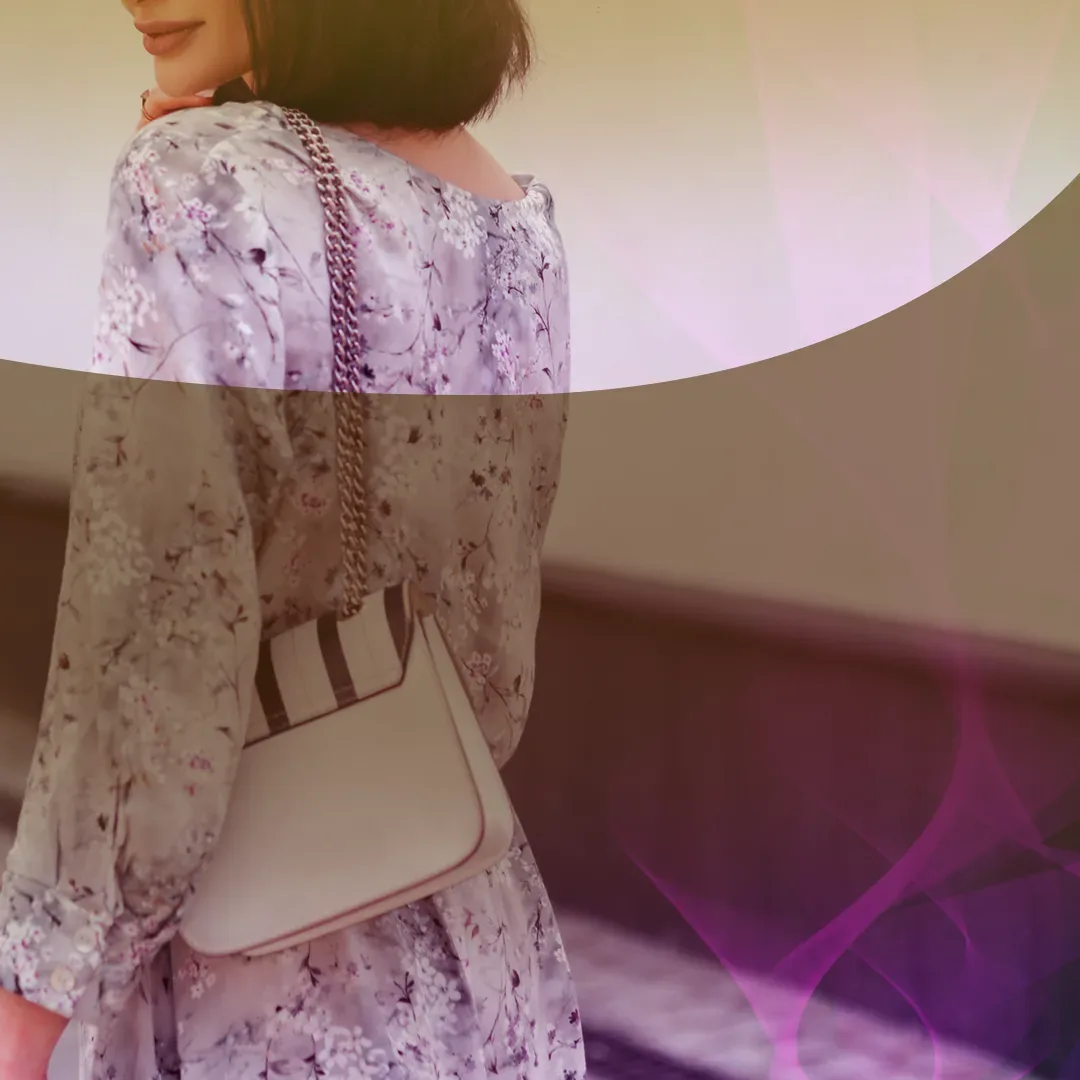 Woman in a floral dress walking with a handbag